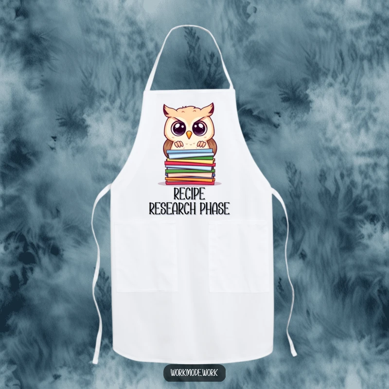 Funny owl apron showing a curious owl with wide eyes, peering intently at a stacked pile of colorful papers, kitchen wear.